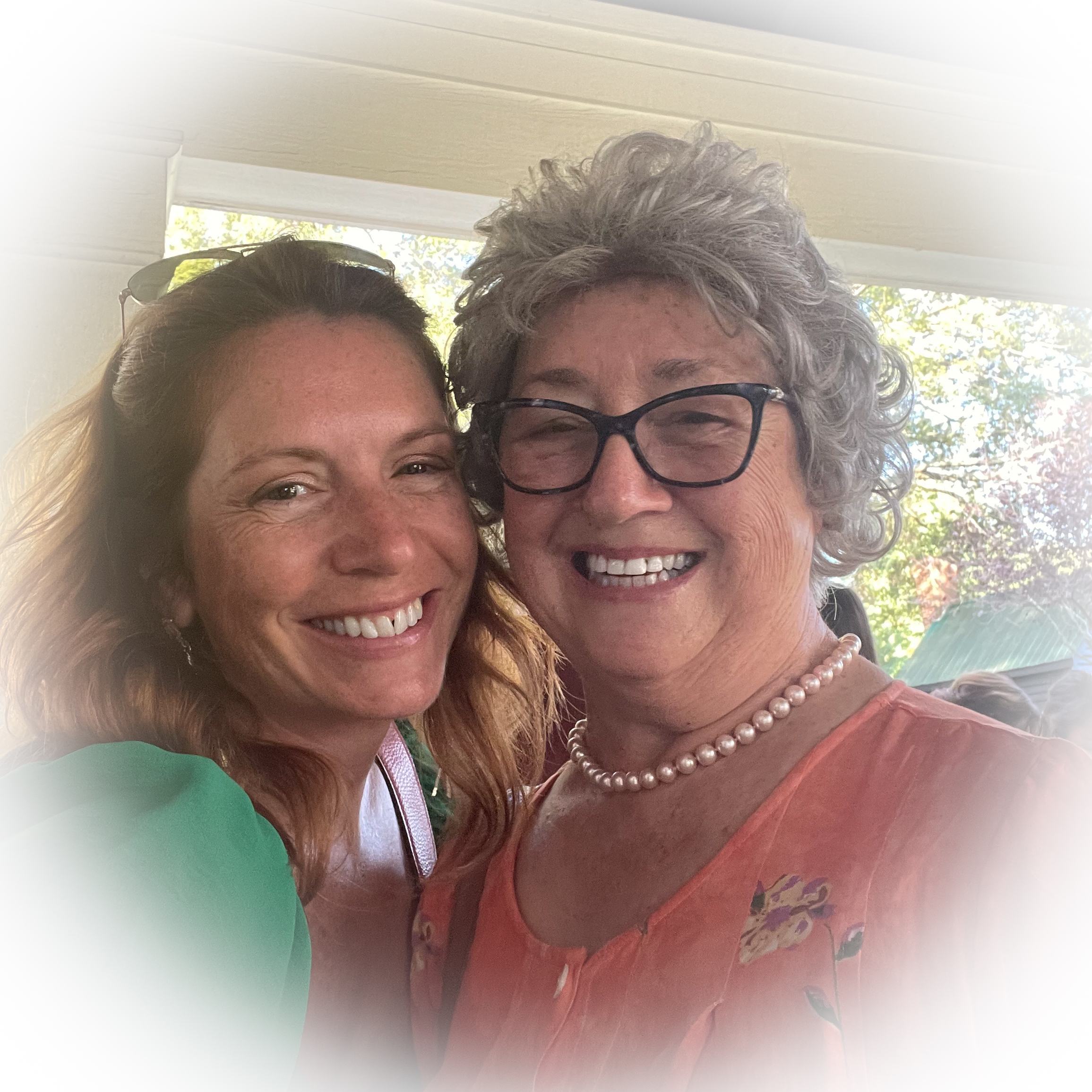 two women standing smiling